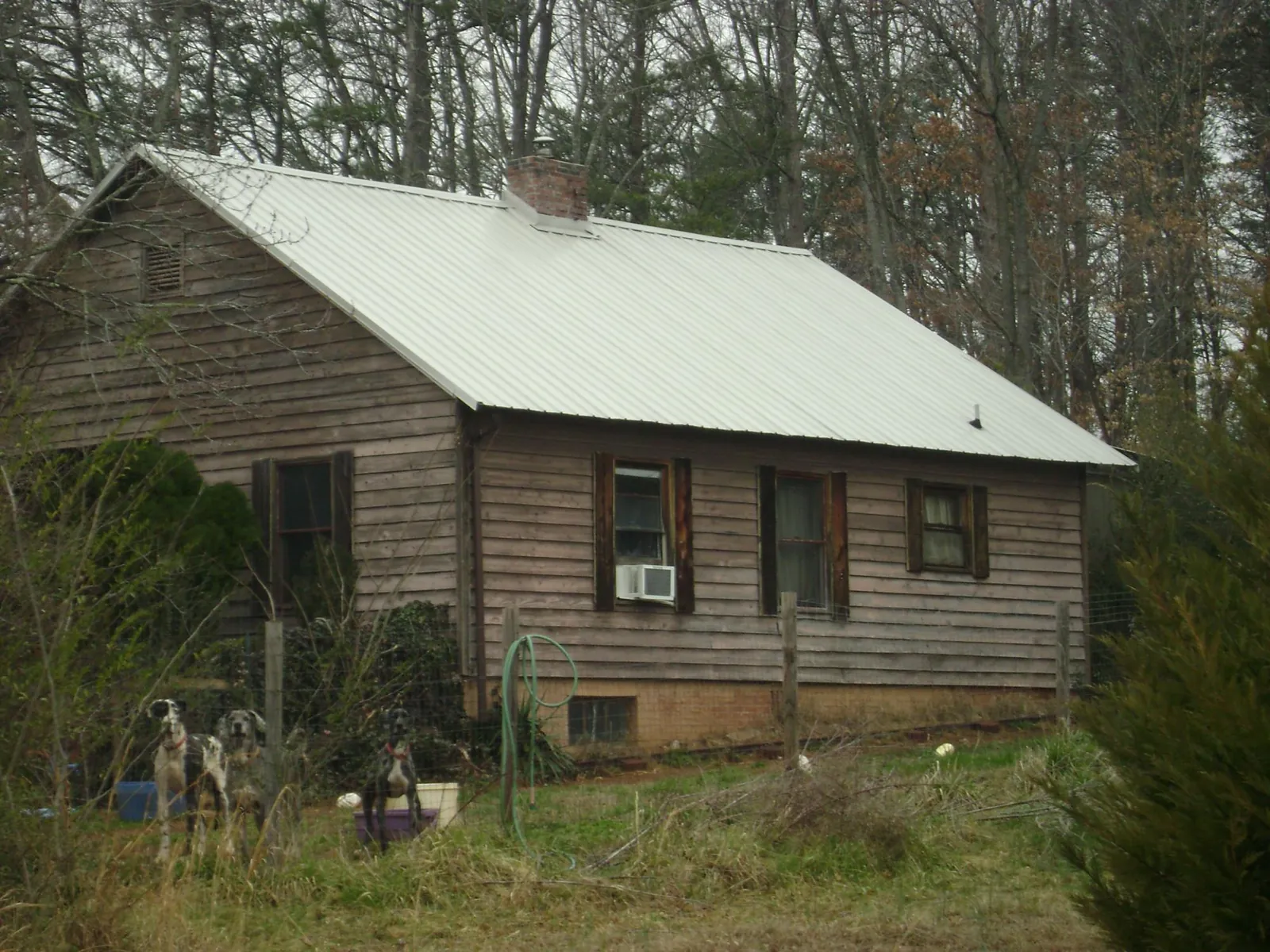 White metal roof on an old wood sided farmhouse, from a Metal Roof Installation job in Dundalk